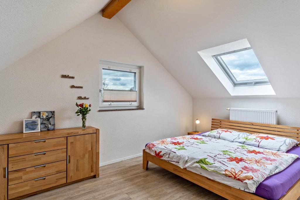 a bedroom with a bed and a dresser and a window at Leppert in Schwanau