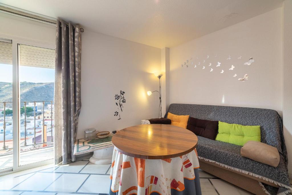 a living room with a couch and a table at Mccoy avenida 3 in Macael