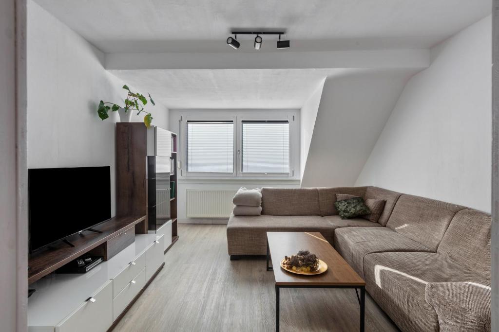 a living room with a couch and a tv at Ferienwohnung am Blitzgi in Wehr
