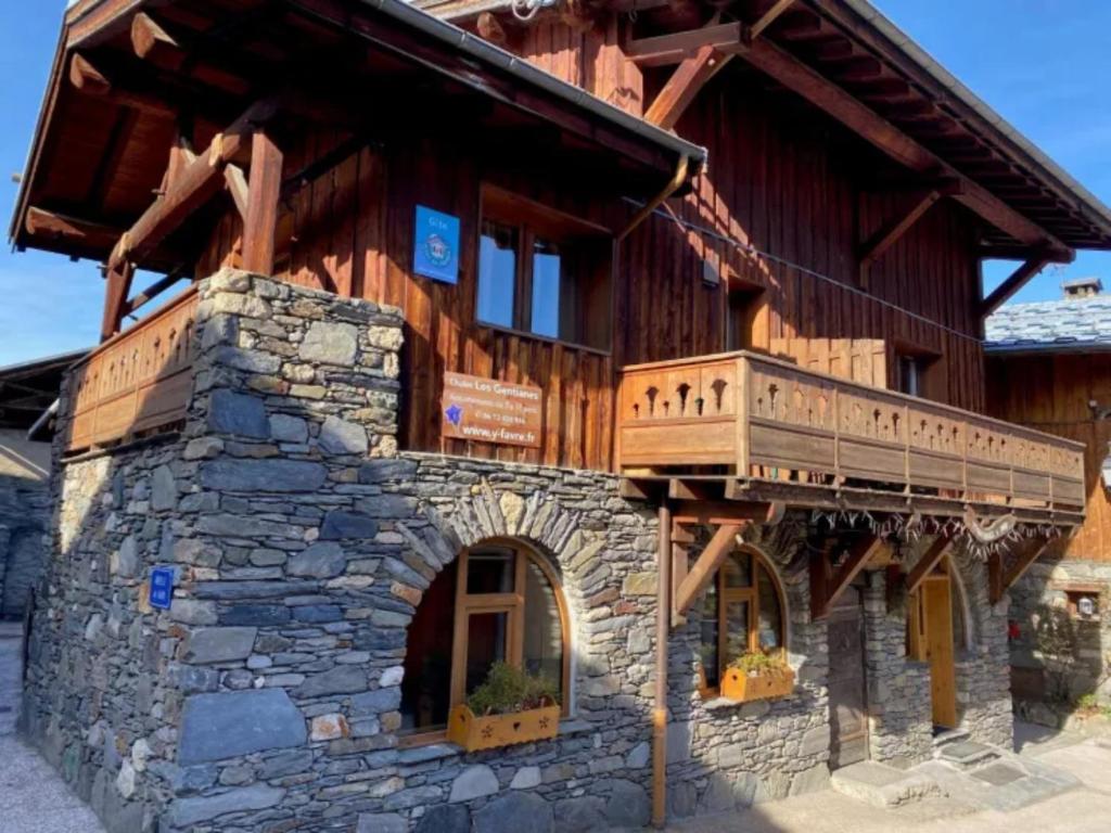 duży drewniany budynek z balkonem w obiekcie Le Génépi w mieście La Plagne Tarentaise