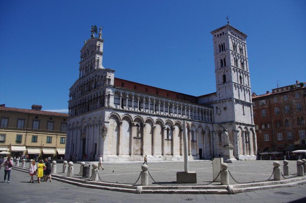 a large building with a clock tower in a city at Residence Al Pozzo in Capannori