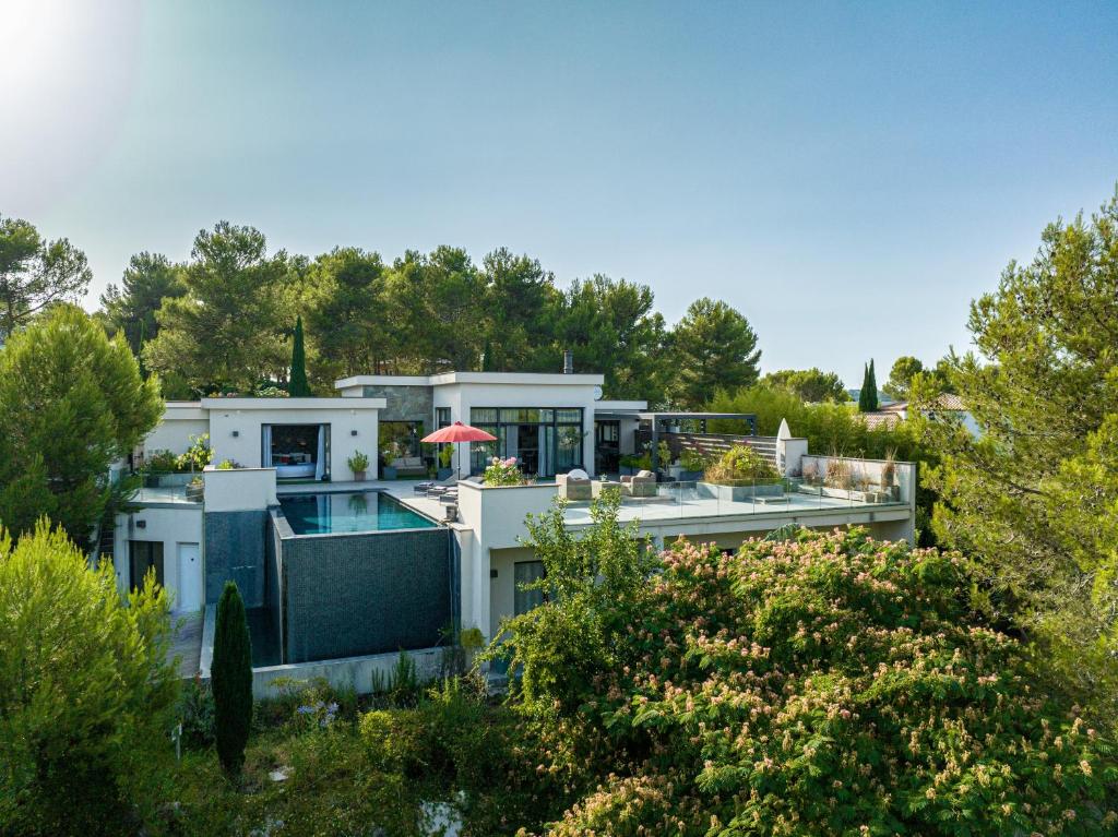 a large white house with a swimming pool at Prestigieuse Villa Spa 2 Piscines in Saint-Gély-du-Fesc
