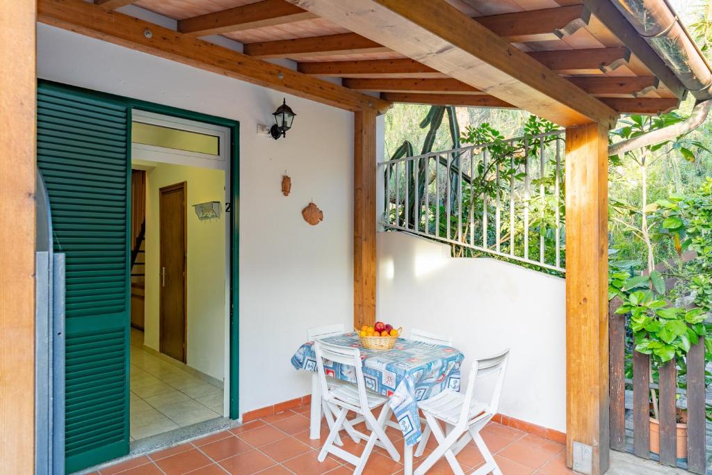 a table and chairs on the porch of a house at Simona Giardino in Fetovaia
