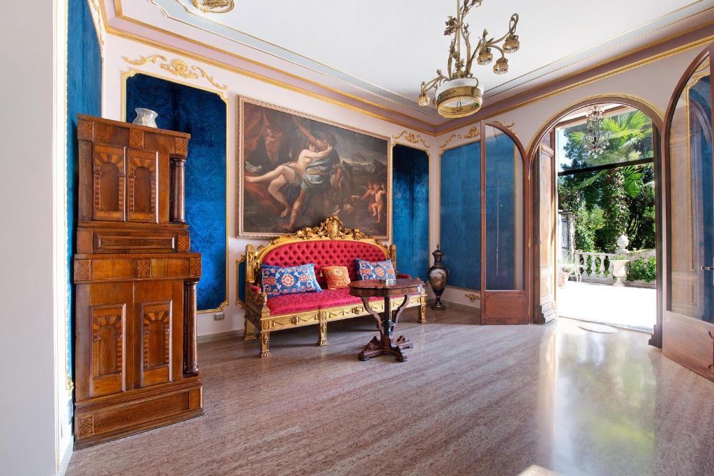 a room with a bed and a painting on the wall at Historic Villa Argegno Como lake in Dizzasco
