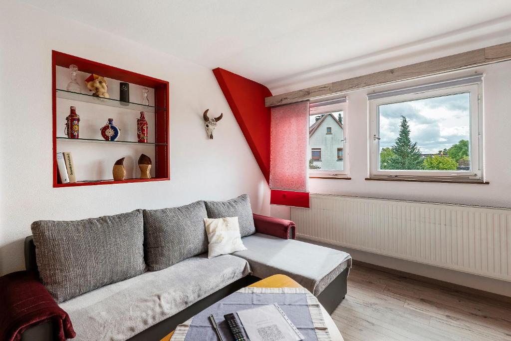 a living room with a couch and a window at Lebensblume in Ilshofen