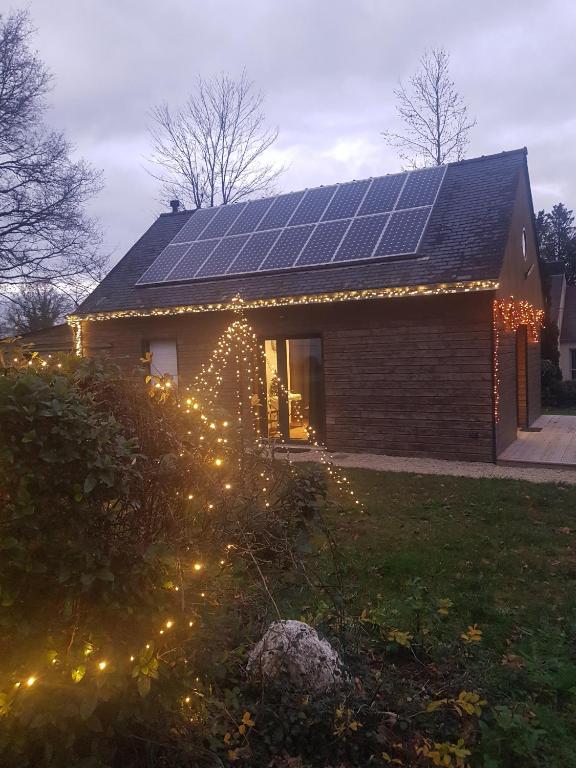 a house with lights and solar panels on the roof at Le Ty Gîte - Sud Morbihan in Théhillac