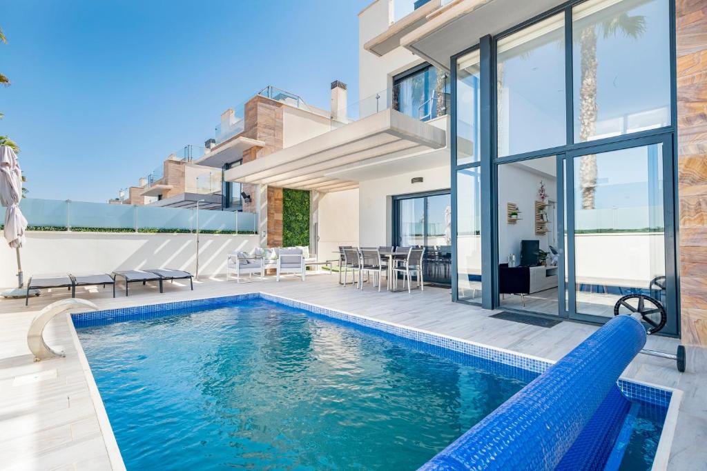a swimming pool in the backyard of a house at Belle in Orihuela Costa