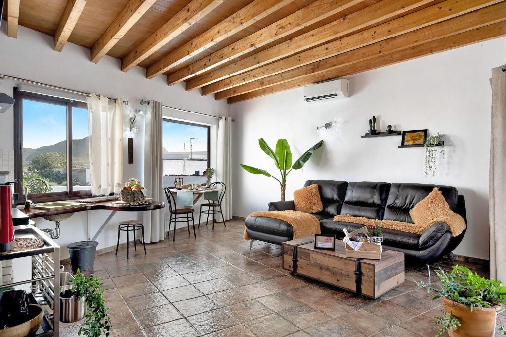 a living room with a couch and a table at Guenia I in Teguise
