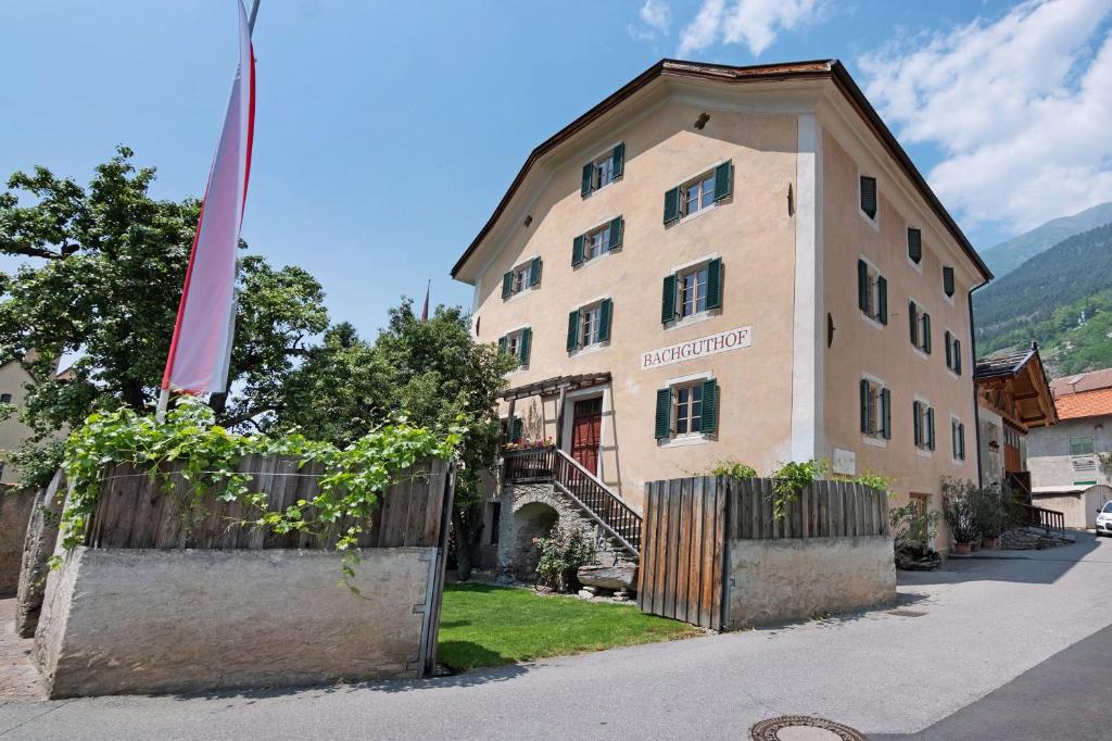 a building with a flag in front of it at Bachguthof in Silandro
