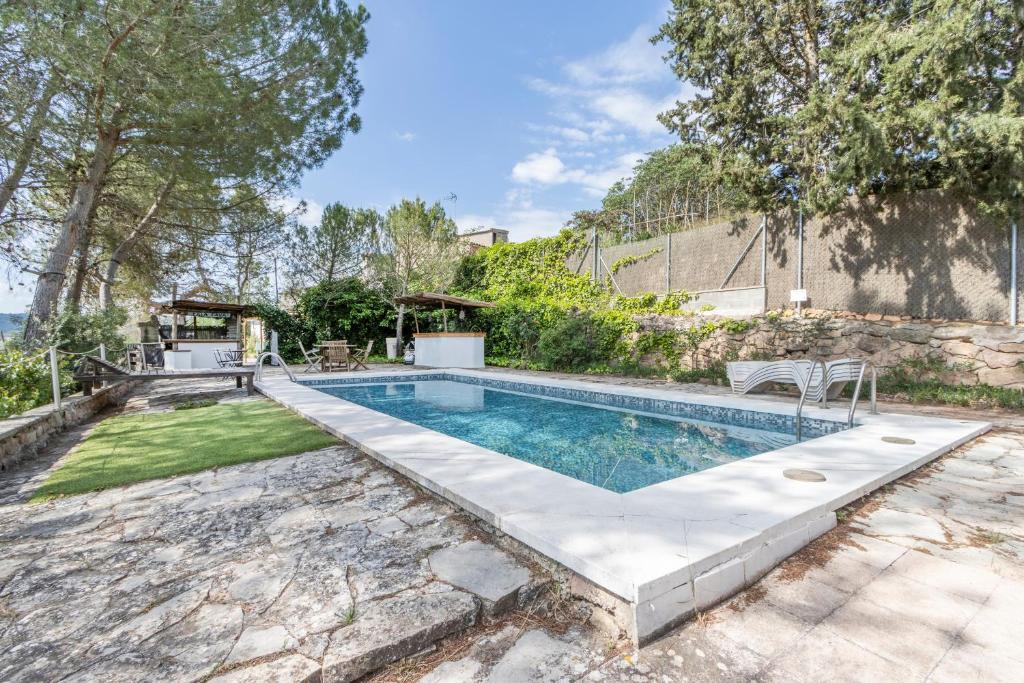 a swimming pool in the backyard of a home at Can Favo in Copóns