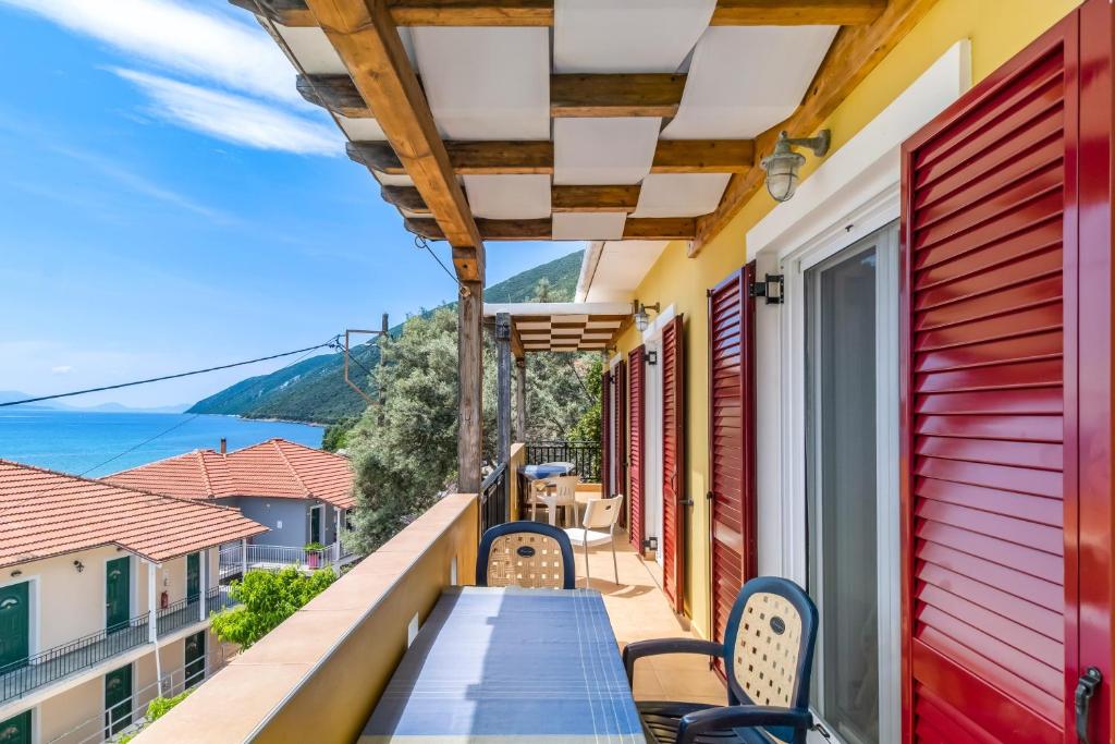 a balcony with chairs and a table and a view of the ocean at Villa Captain Fotis 4 in Póndi