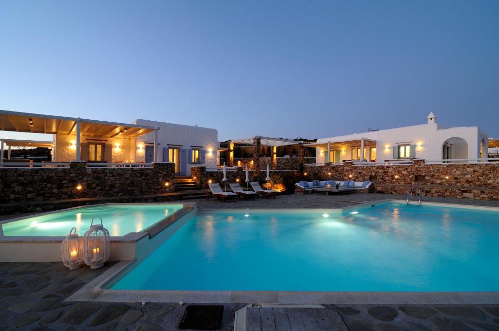 a swimming pool in a resort at night at Villa St' Astra in Koufonisia