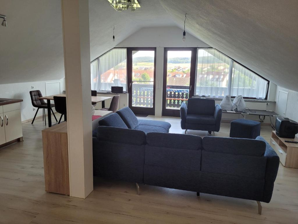 a living room with a blue couch and a table at Haus Bergblick 1 in Utzmemmingen