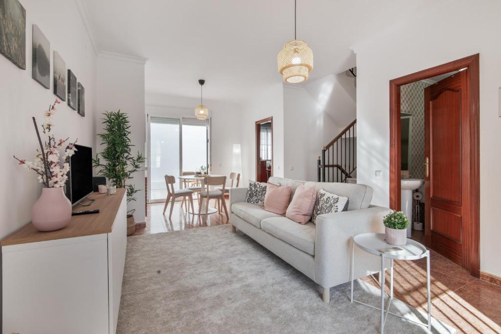 a living room with a couch and a table at Villa Marília in Ayamonte