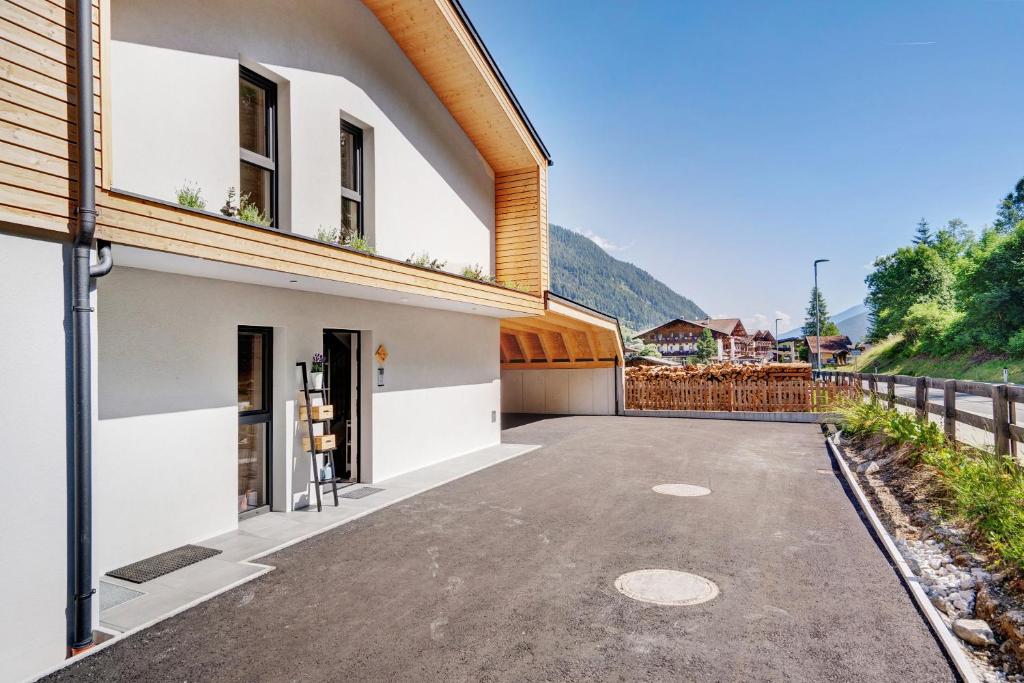 an empty driveway in front of a house at Stackler54 - mit Balkon in Neustift im Stubaital
