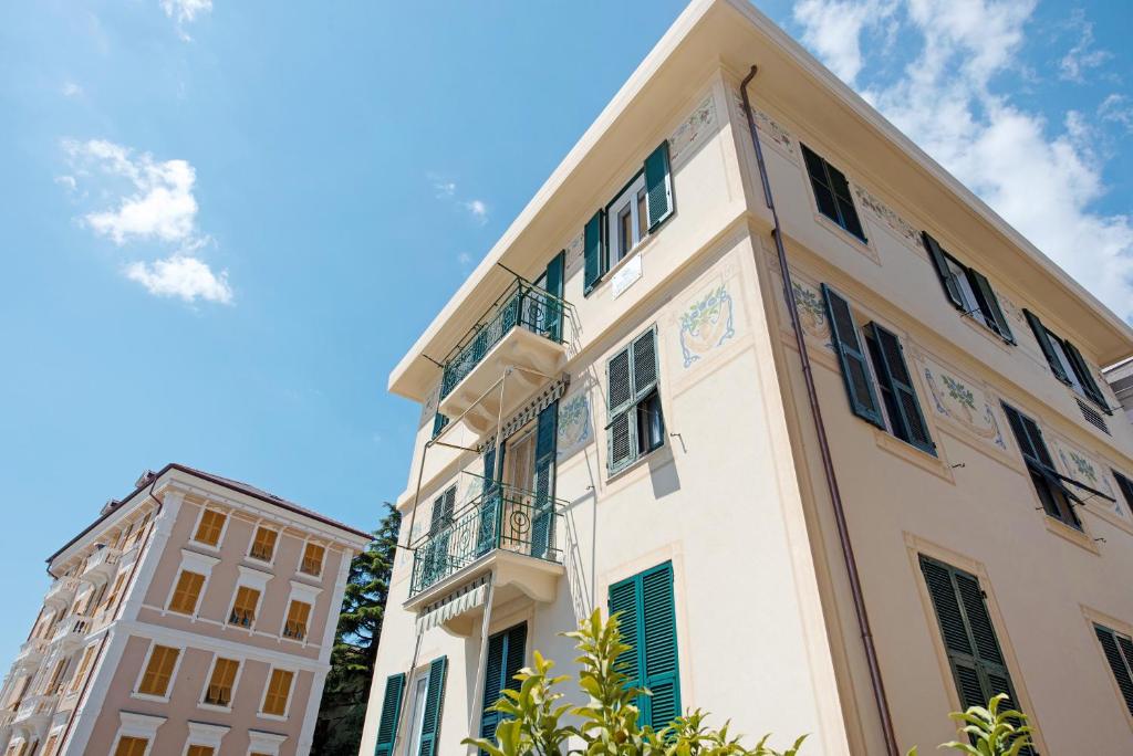 a white building with a balcony and two buildings at Bilocale Mezzano in centro in Varazze