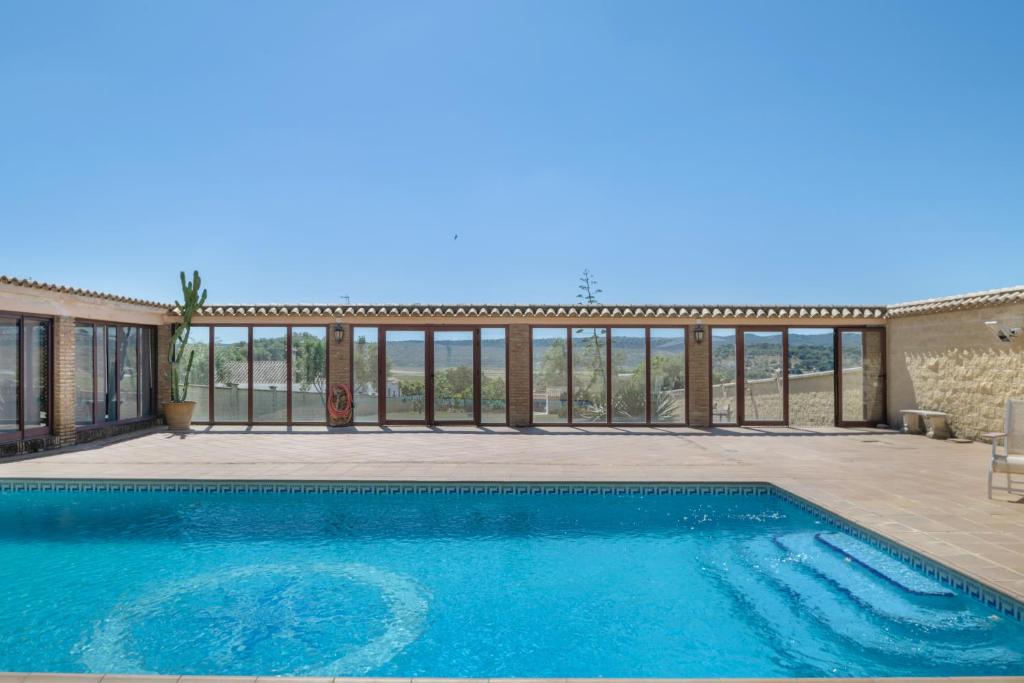a swimming pool in front of a house at Casa Altamar in Barbate