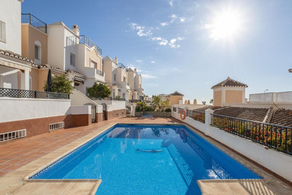 a swimming pool in the backyard of a house at Casa Chloe in Nerja
