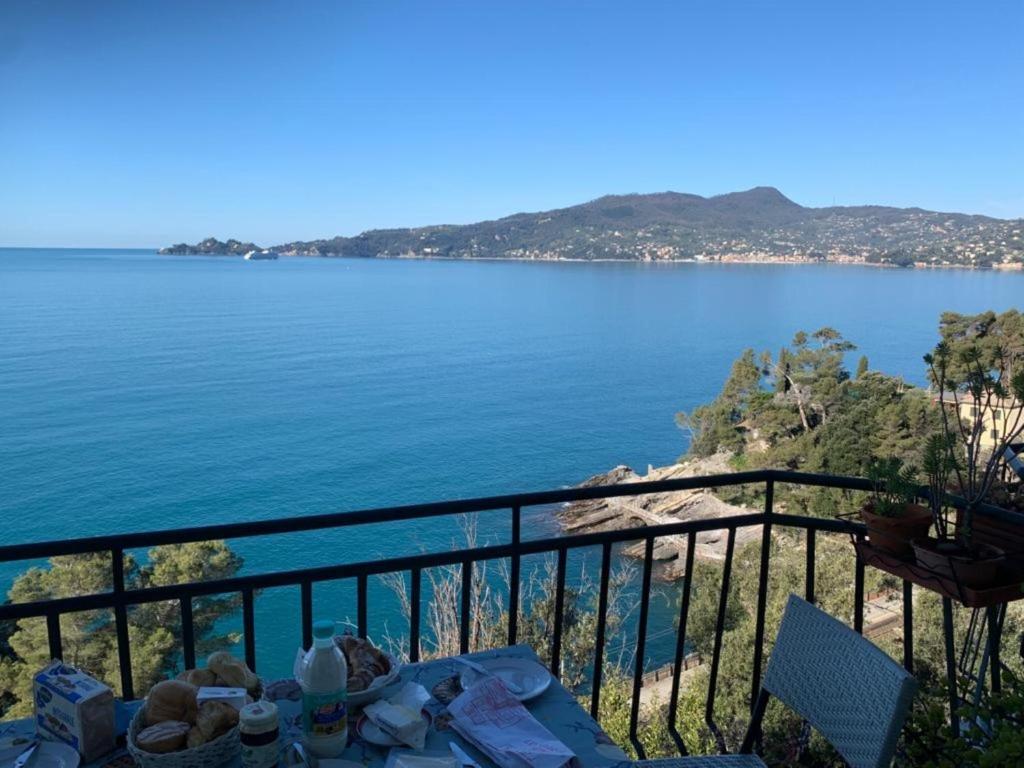a table on a balcony with a view of the water at La Solatia in Zoagli