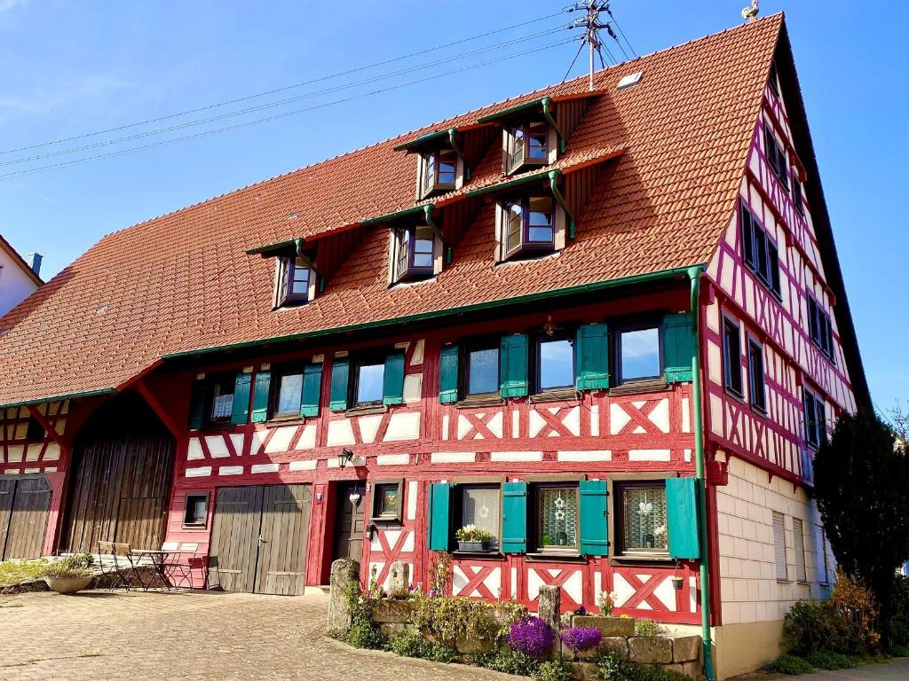 a red and white building with a brown roof at Ferienwohnungen Im Eugenhaus in Rosenfeld