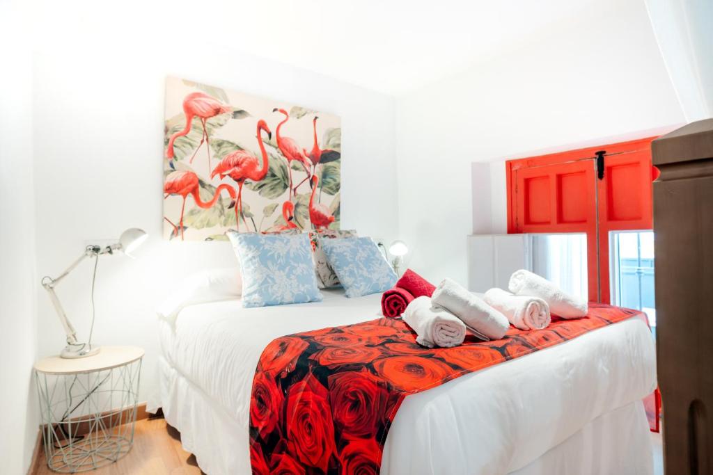 a bedroom with a bed with towels on it at Duplex Seville-Historic Center in Seville