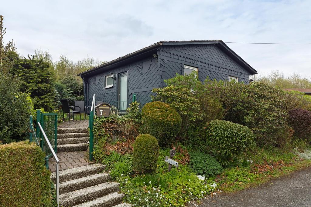 a black house with stairs in front of it at Sauerland Oase in Meschede