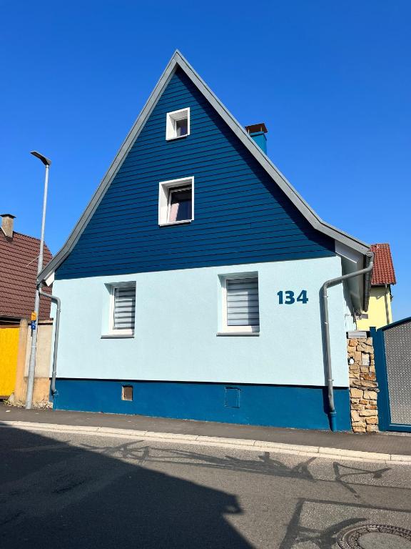 a blue and white building on the side of a street at Ferienwohnung Blaues Haus in Ubstadt-Weiher