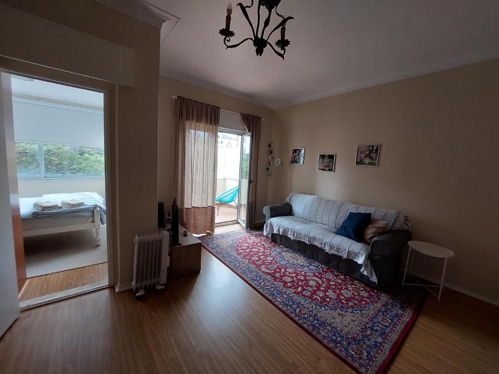 a living room with a couch and a window at Estoril Sea You in Estoril