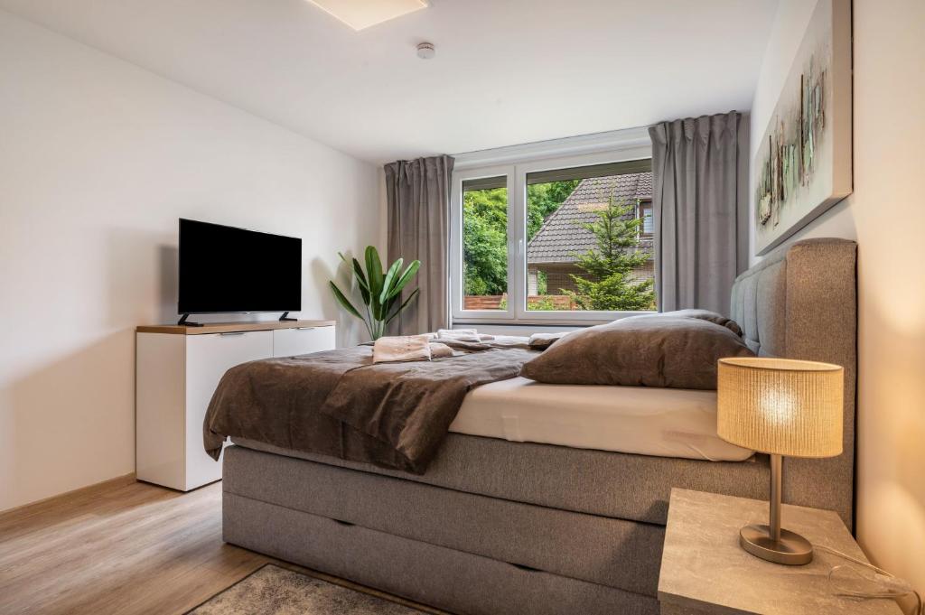 a bedroom with a large bed and a window at Kleines Glück in Delmenhorst