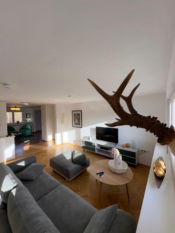 a living room with a couch and a table at Auerer Retreat in Frauenau