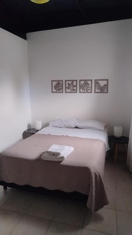 a bedroom with a large bed with two tables at Alojamiento El Centenario in San Martín