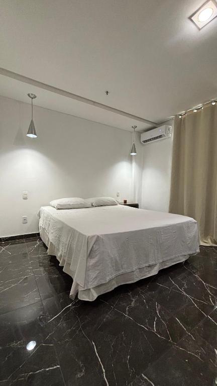 a bedroom with a large white bed in a room at Lindo Flat Completo 311 in Nova Iguaçu