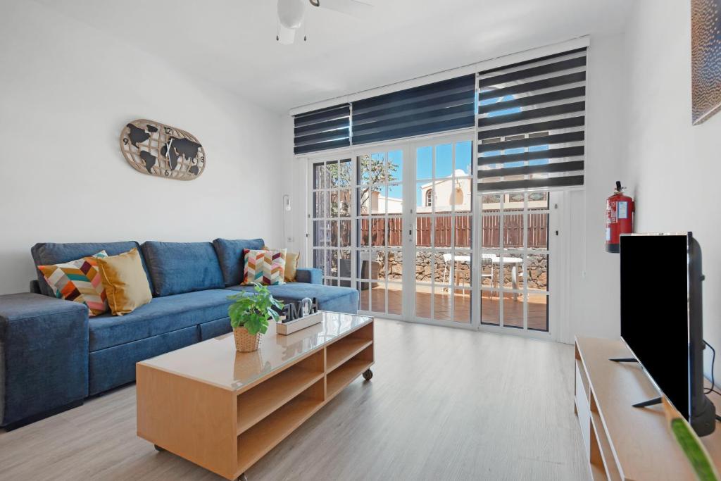a living room with a blue couch and a coffee table at Casa Alsa Beach in Icod de los Vinos