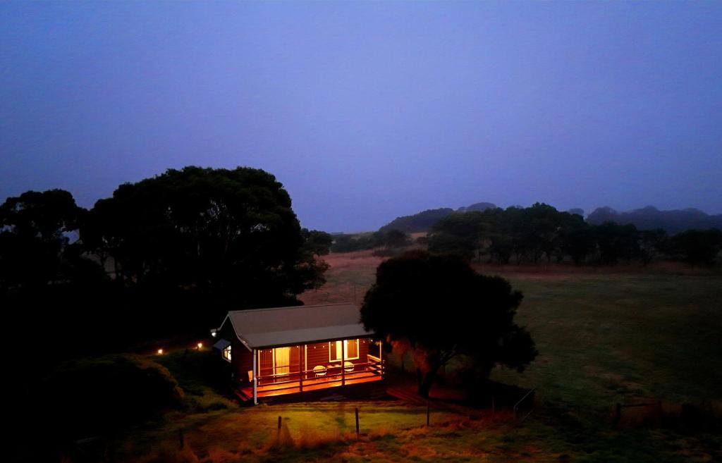 a small cabin in a field at night at 12 apostles cottages in Princetown