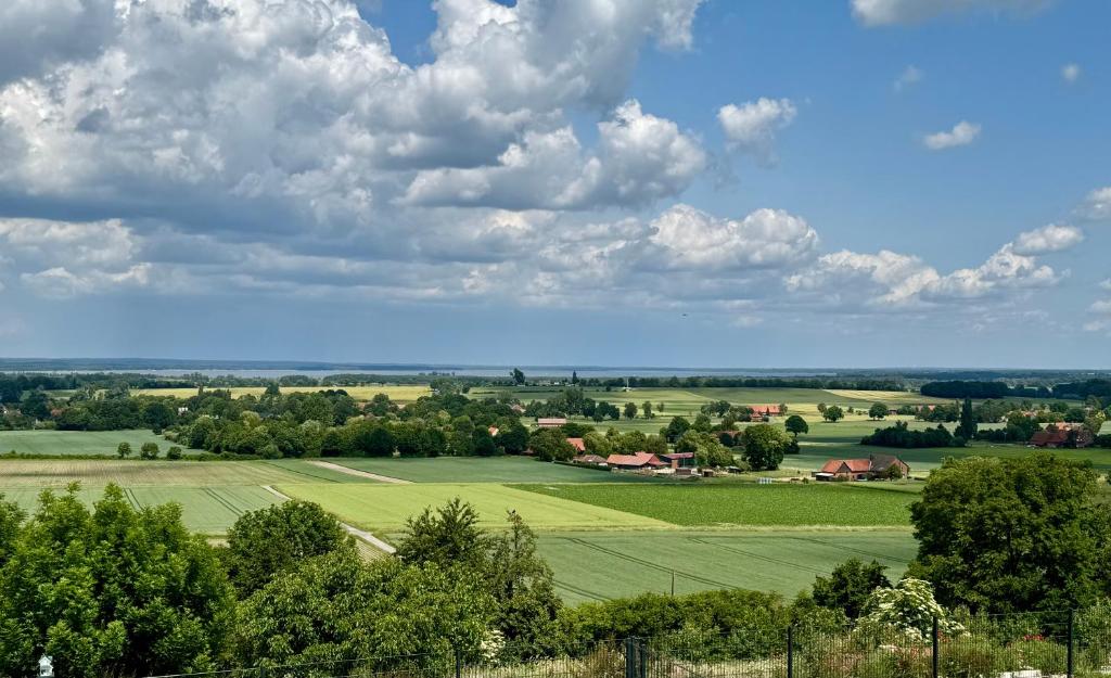 a view of a green field under a cloudy sky at Berg und Meer in WÃ¶lpinghausen