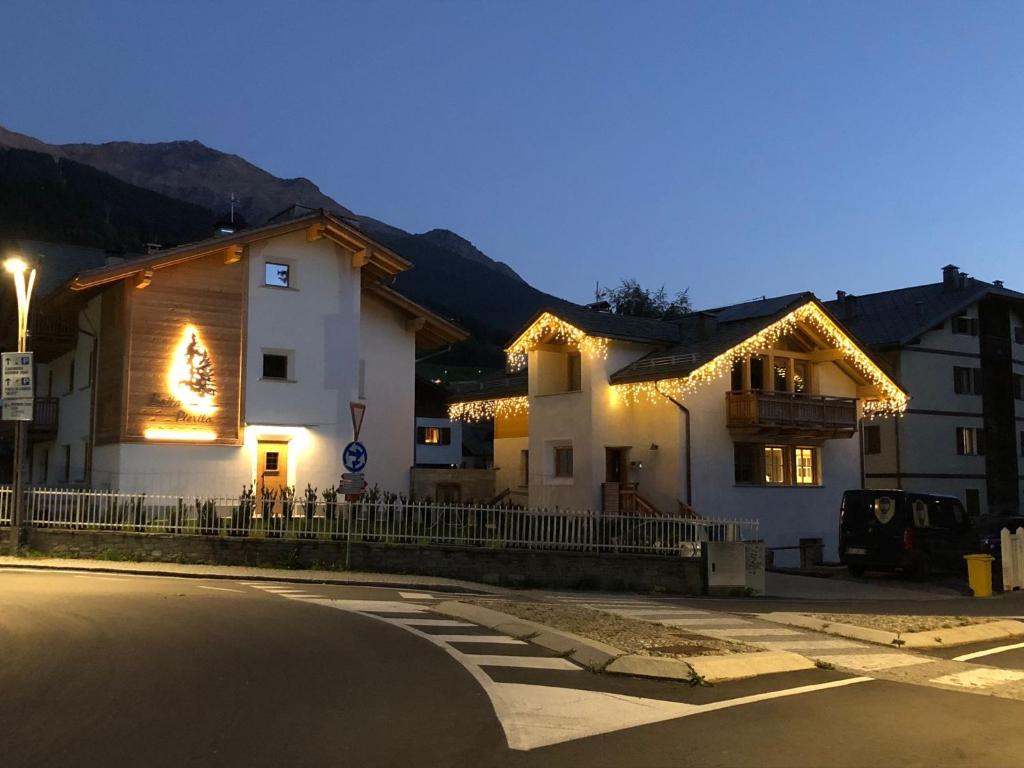 a building with lights on the side of a street at Chalet Pieri - Appartamento Temelin in Bormio