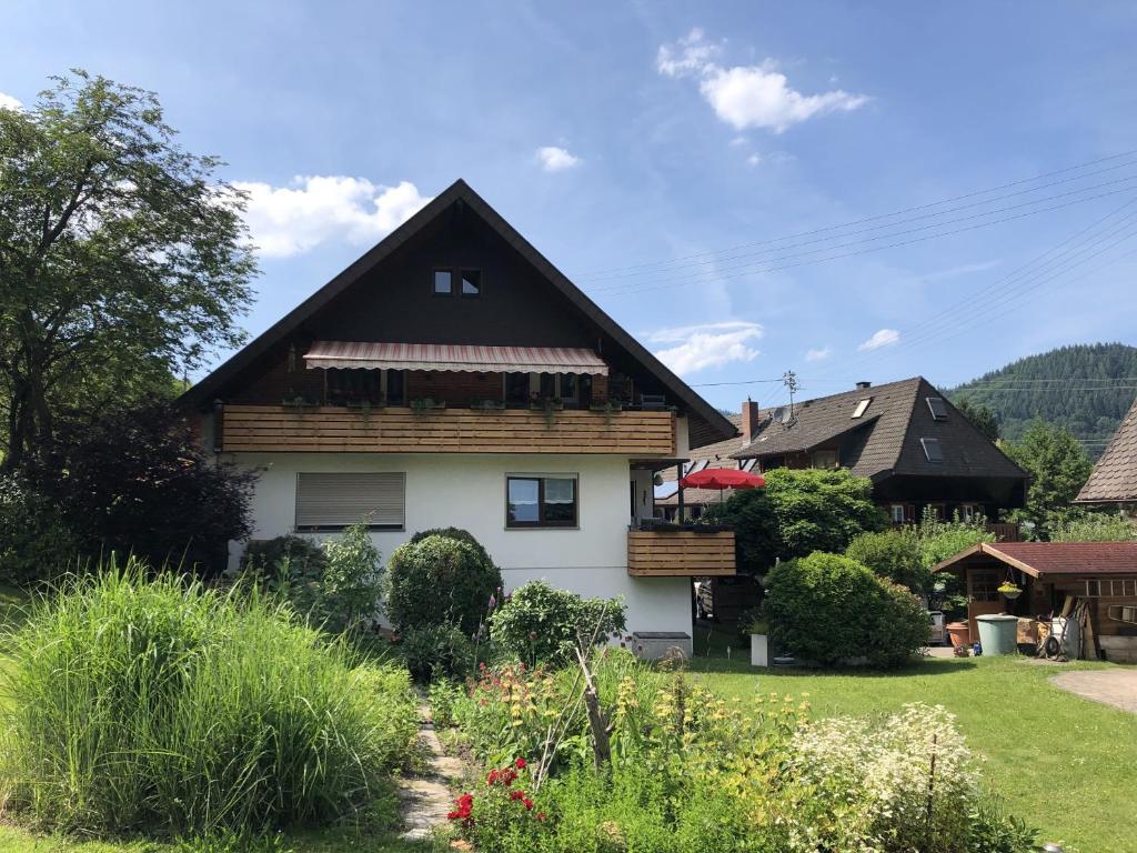 a white house with a black roof at Ferienwohnung Sägegasse, Typ A in Münstertal