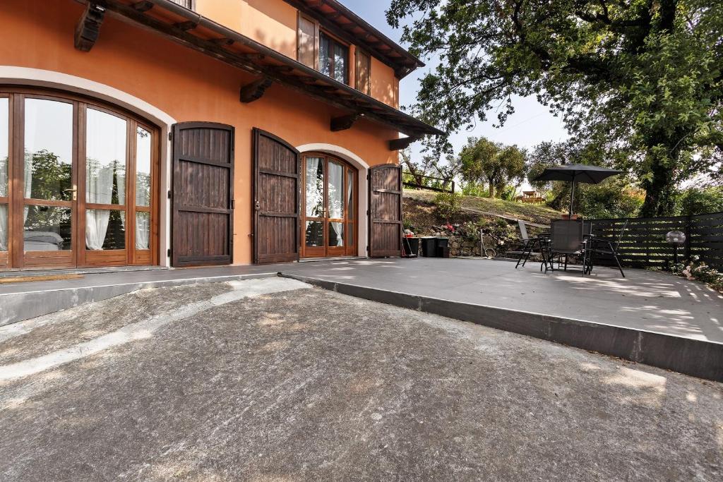 an outdoor patio of a house with a table and chairs at Agriturismo Per Caso in Carignano