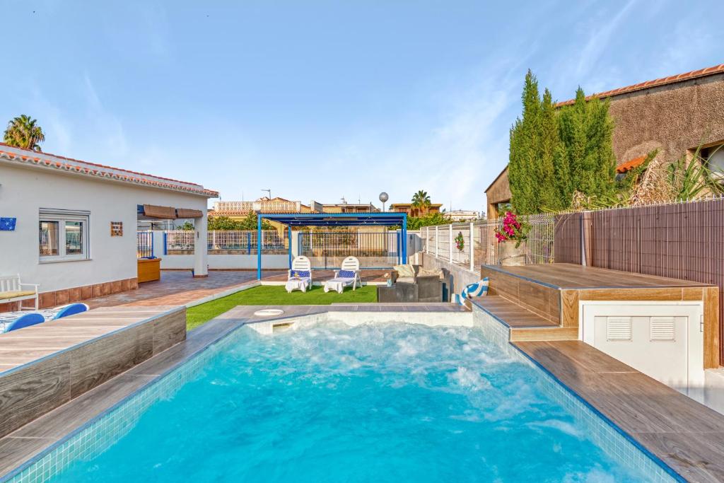 a swimming pool in the backyard of a house at Villa Mediterraneo in Oliva