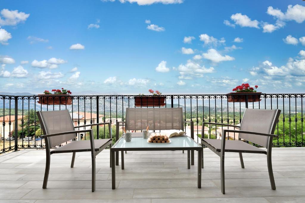 a patio with two chairs and a table on a balcony at Dolcecasa in Dorgali
