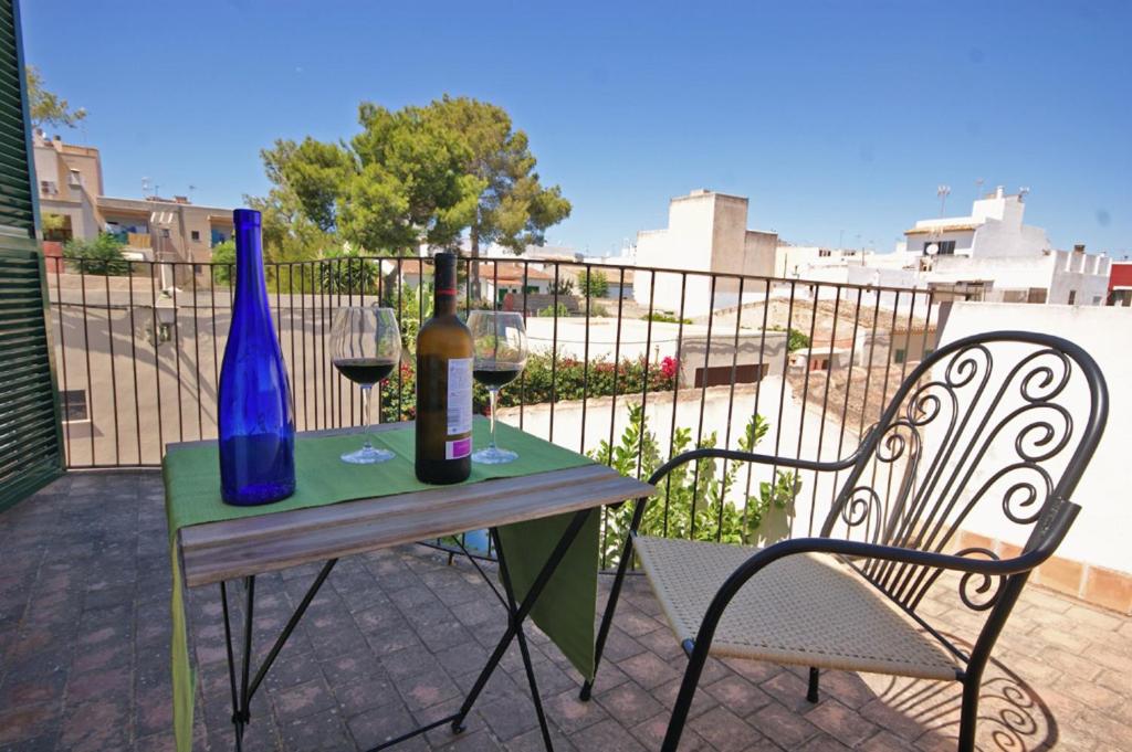 a table with two bottles of wine and a glass at Sa Portassa in Felanitx