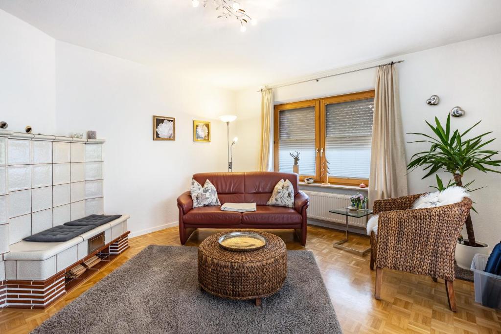 a living room with a couch and a chair at Haus Regina in Löffingen
