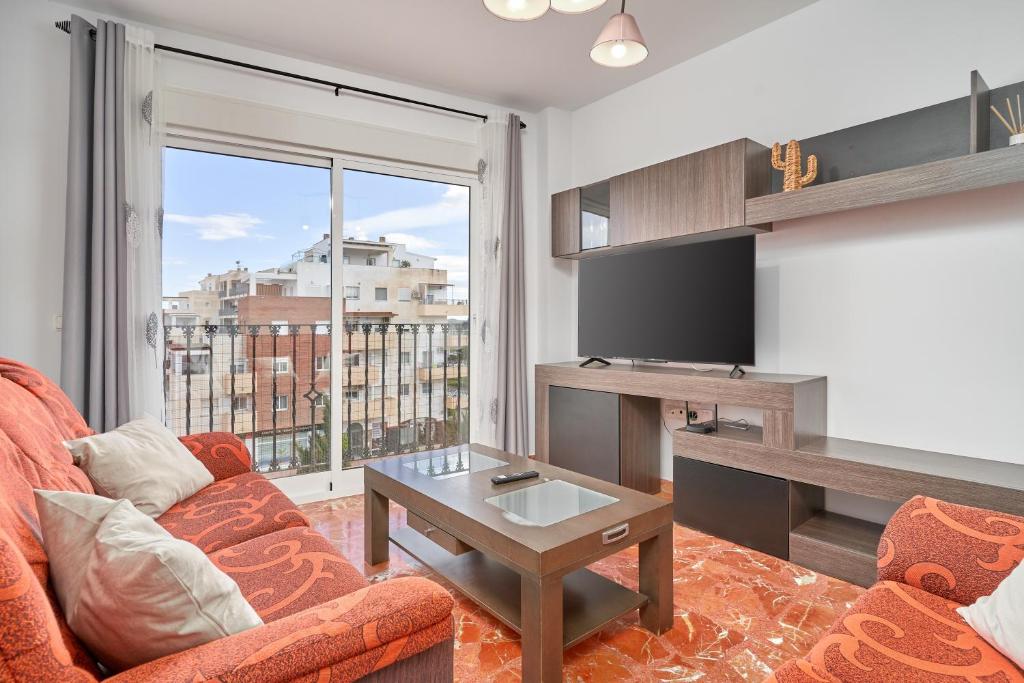 a living room with a couch and a table at Casa Axarquia 2 in Vélez-Málaga