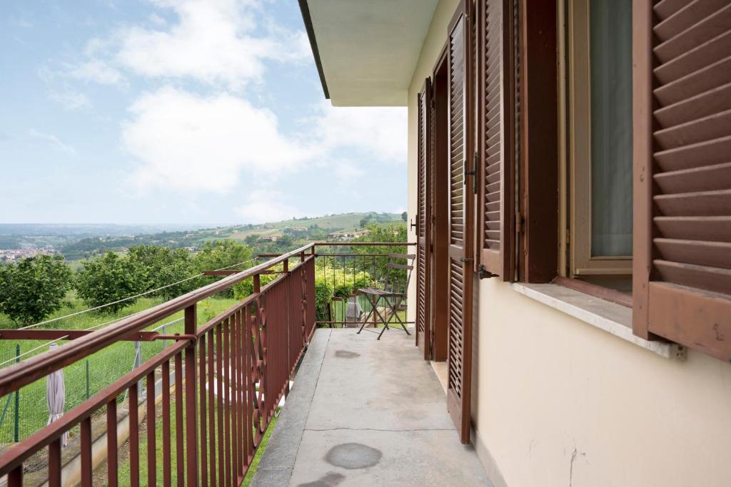 a balcony with a view of the mountains at Casa Pianezzo Dogliani in Dogliani
