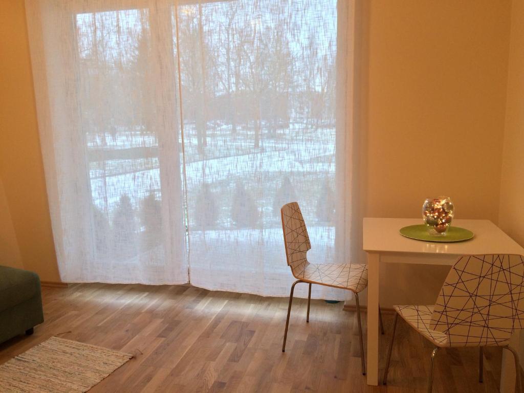a dining room with a table and a window at Fortuuna 5 Apartment in Tartu