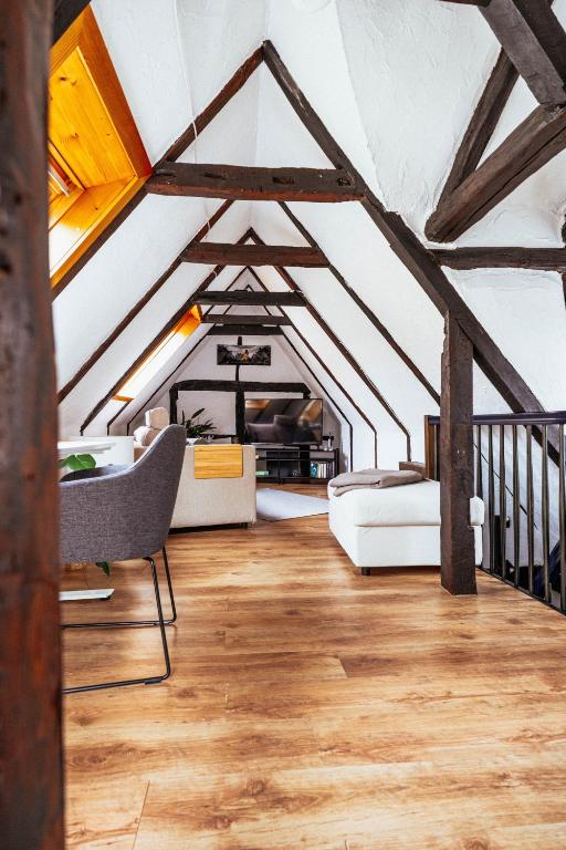 a living room with wooden floors and beams at Lauterbach im Herzen der Altstadt in Lauterbach