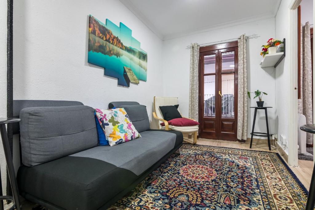 a living room with a couch and a rug at Apto Casco viejo Castro Urdiales in Castro-Urdiales