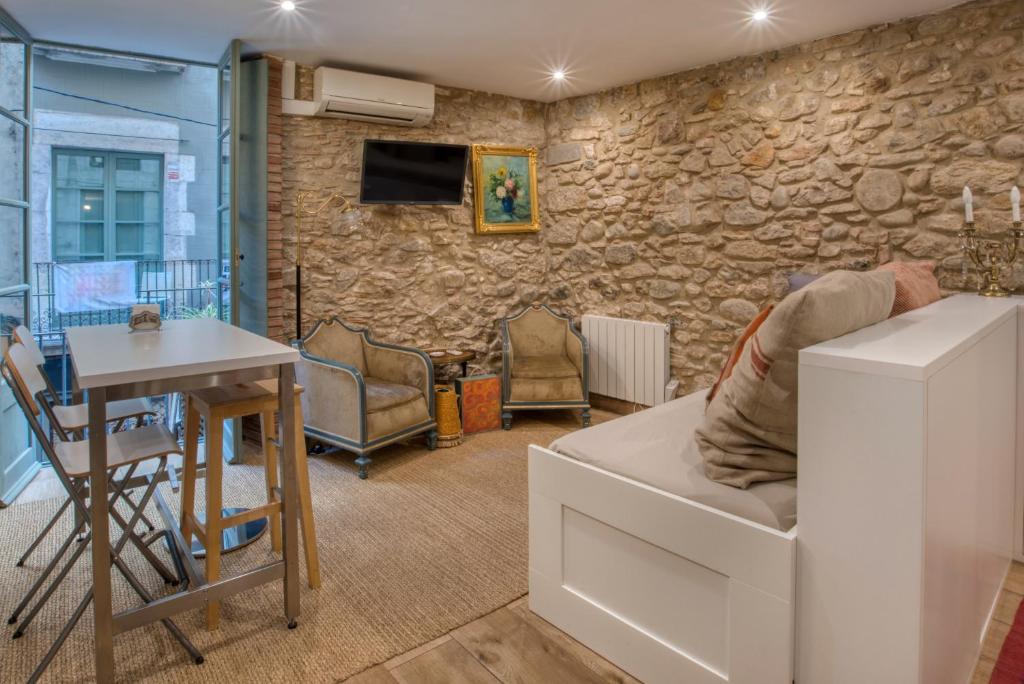 a living room with a stone wall at Old Side Girona one in Girona