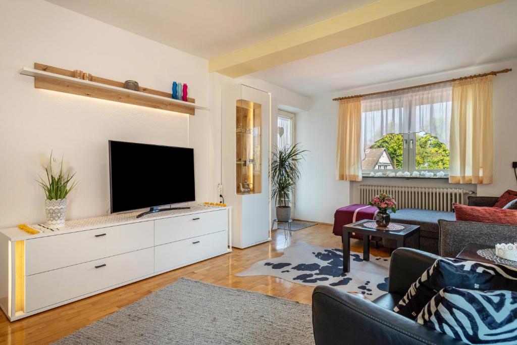 a living room with a tv on a white dresser at Mein lieber Schwan in Lindau