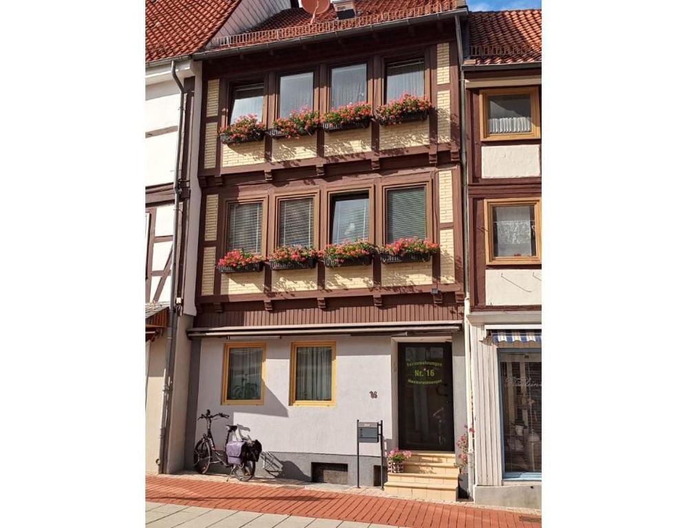 a building with flower boxes on the side of it at Haus am Markt Fewo 2 in Schöningen